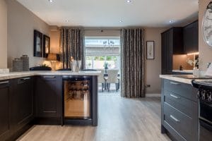 Black Kitchen Leading To Dining Room