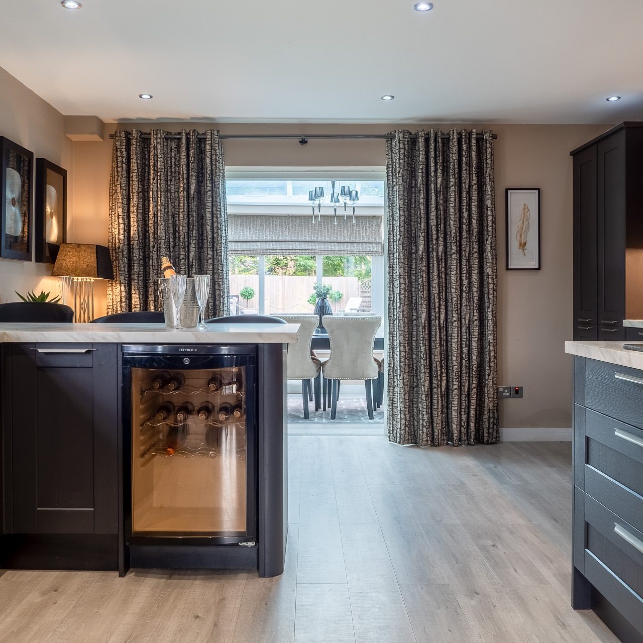 Black Kitchen Leading To Dining Room